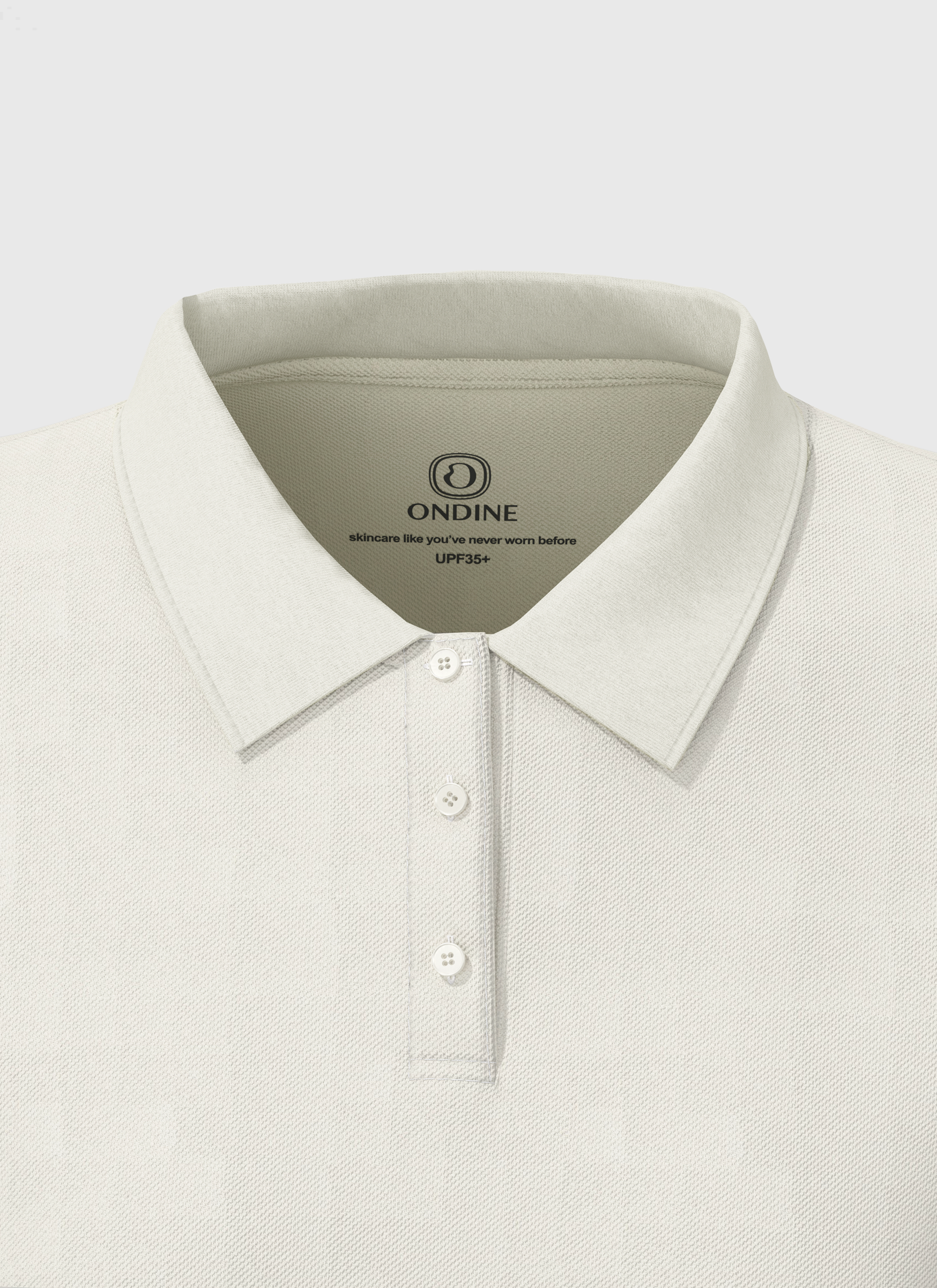 Close-up of Stella Ondine long sleeve polo collar and button placket in soft, breathable fabric.