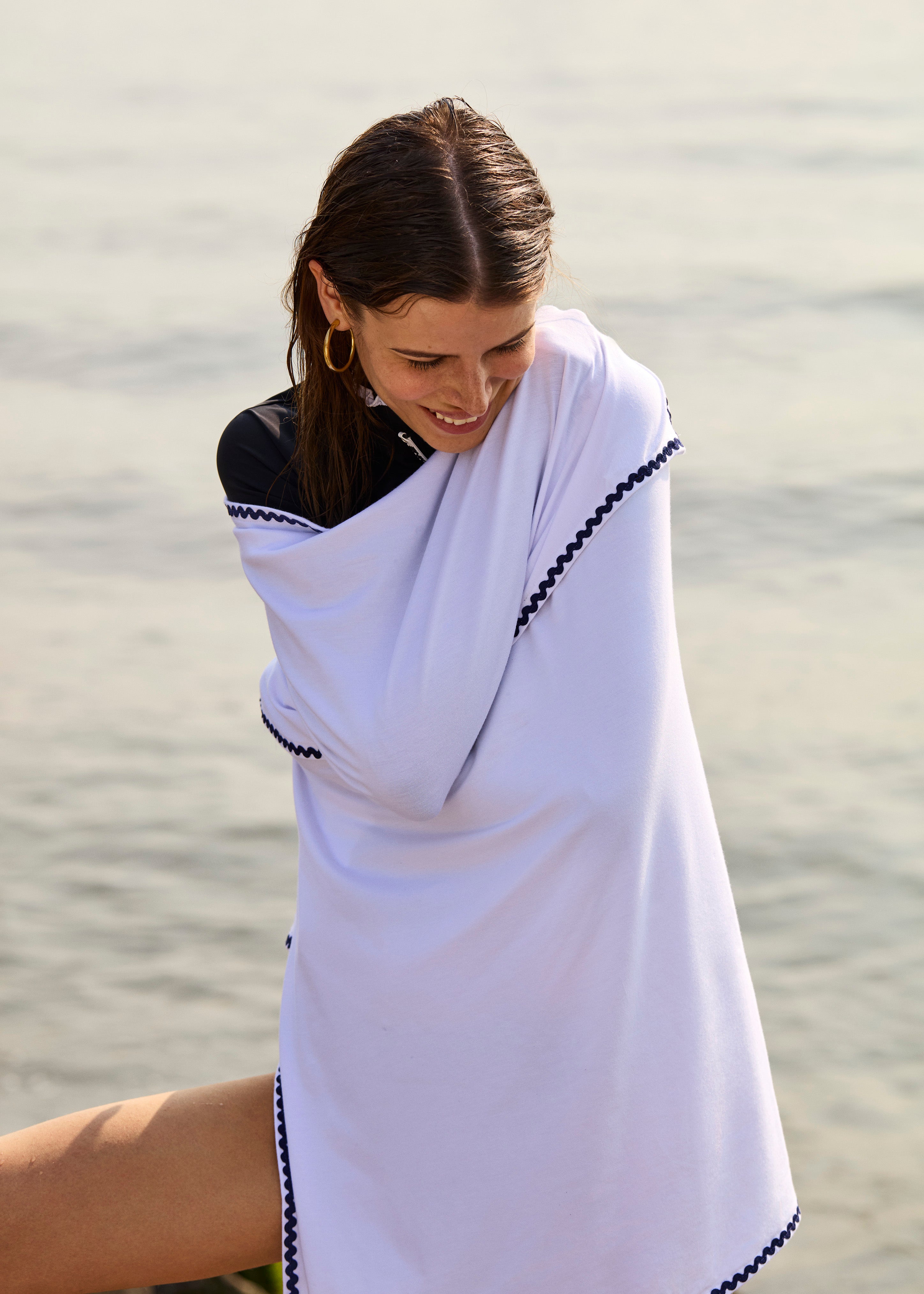 Model wearing Ondine Elisa Sun Blanket UPF 50 over shoulders for stylish sun protection.