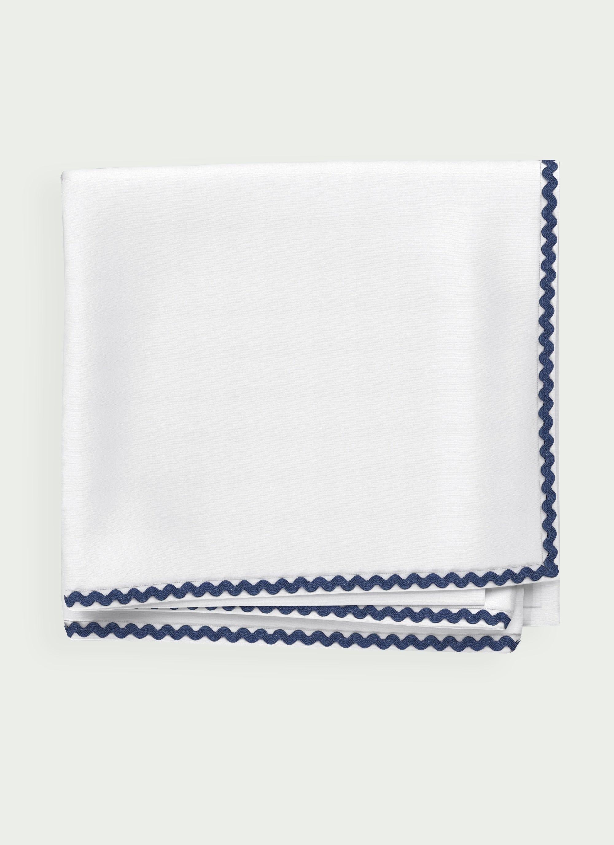 Folded view of white Ondine Elisa Sun Blanket showing soft lightweight fabric texture.