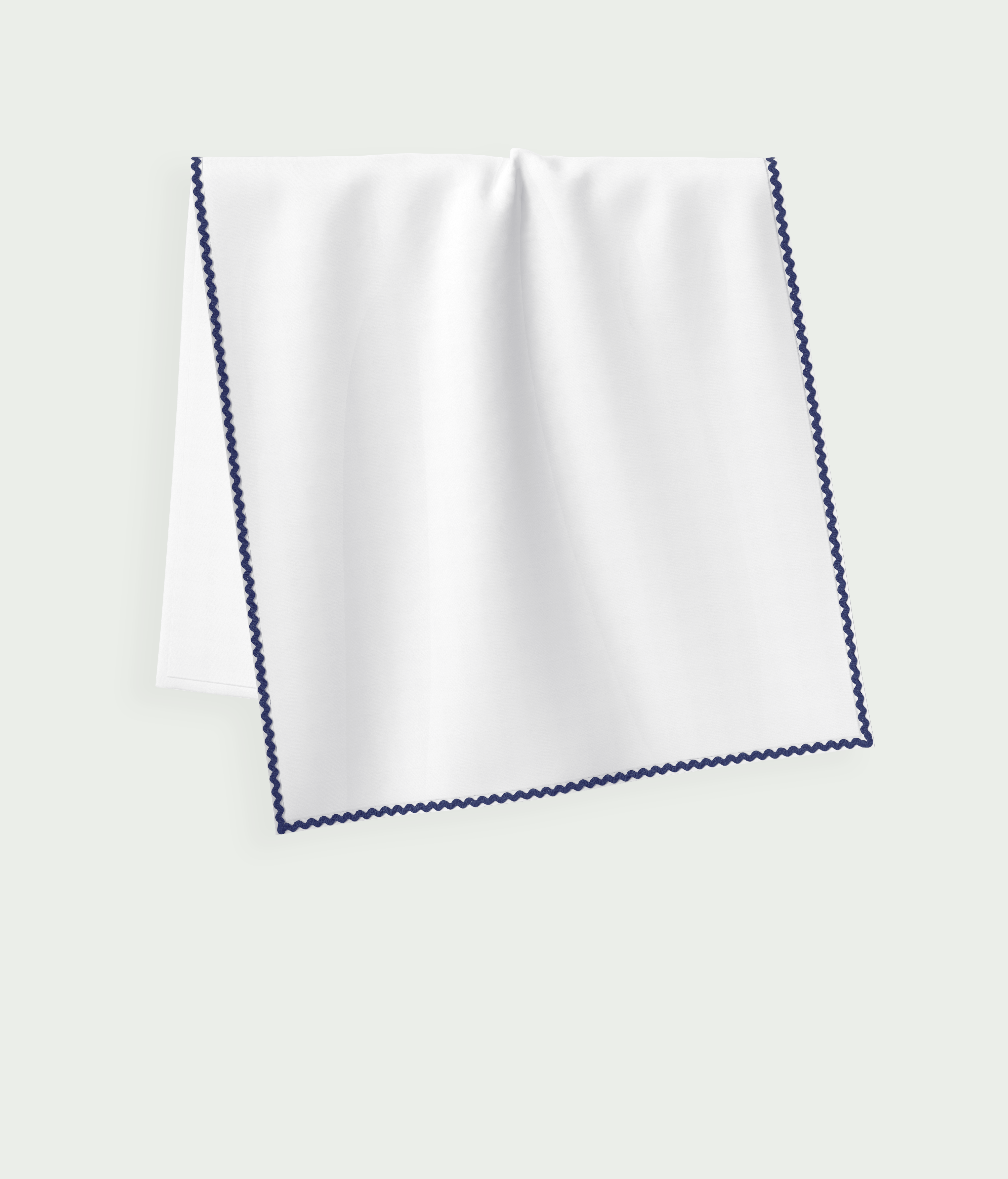 Folded white Ondine Elisa Sun Blanket with navy trim, UPF 50+ sun protection.